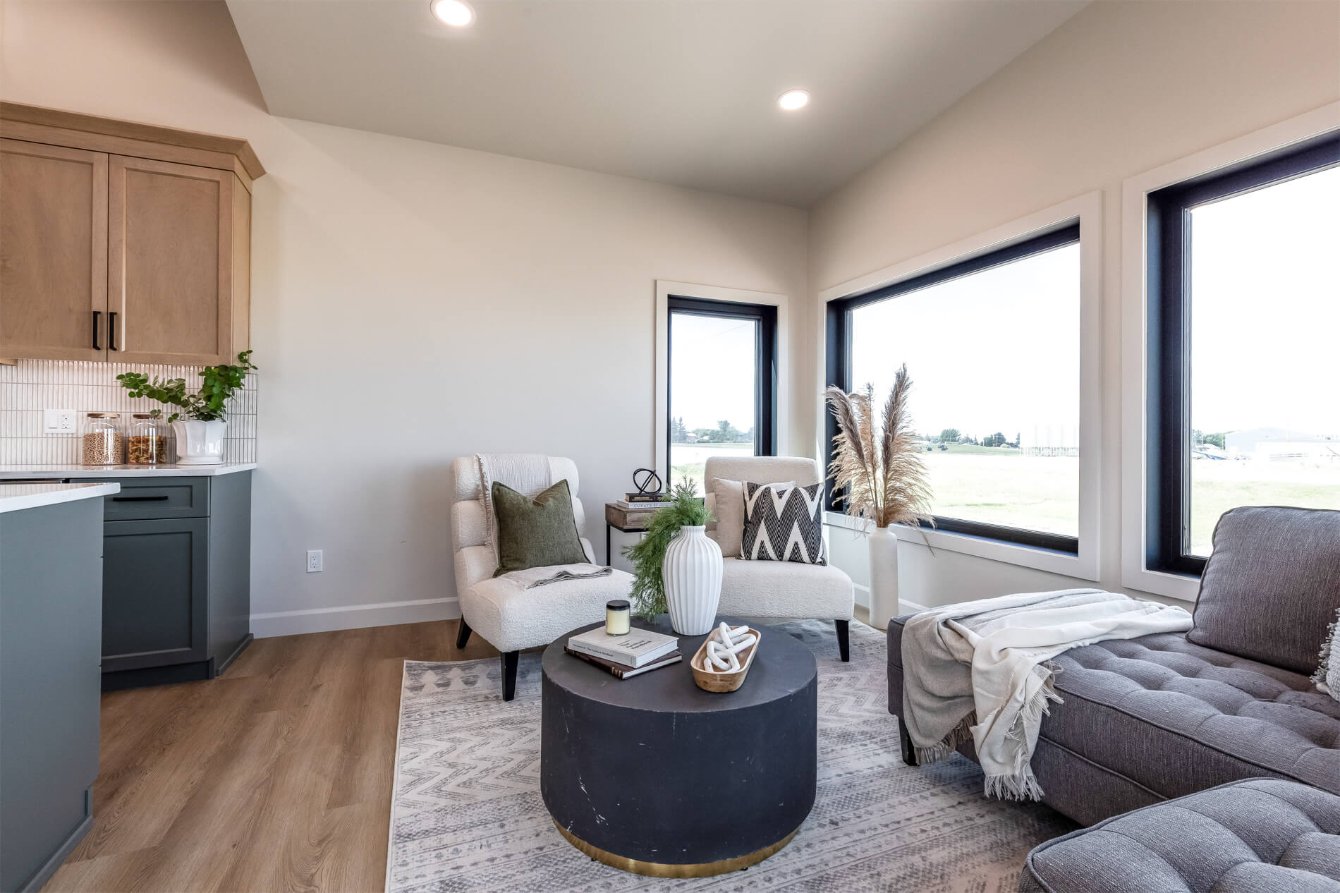A spacious living room in a tiny home with large windows and high ceilings