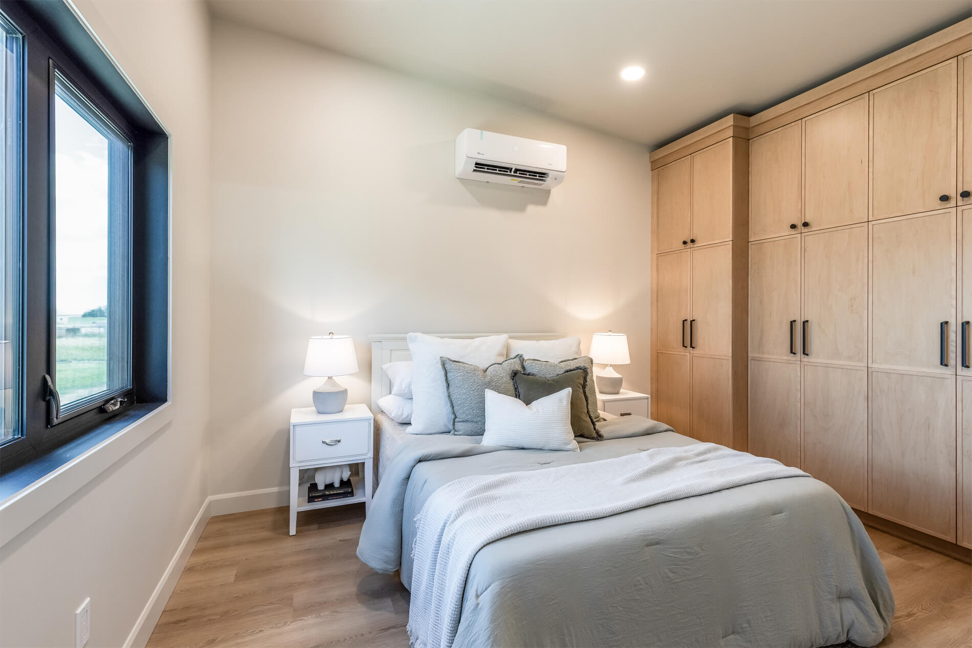 Tiny home master bedroom with ample storage and high celings