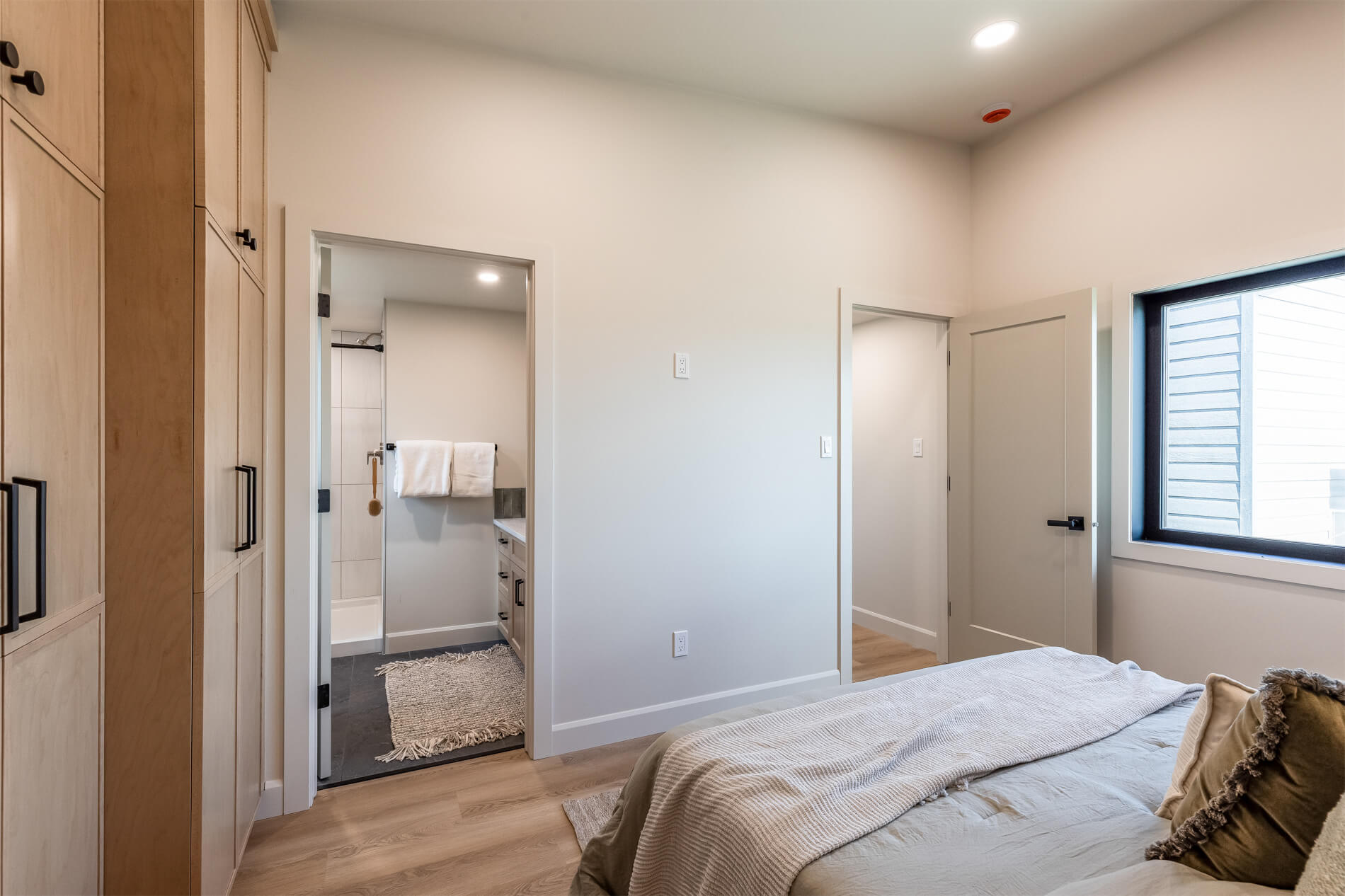 A tiny home master bedroom with an ensuite bathroom