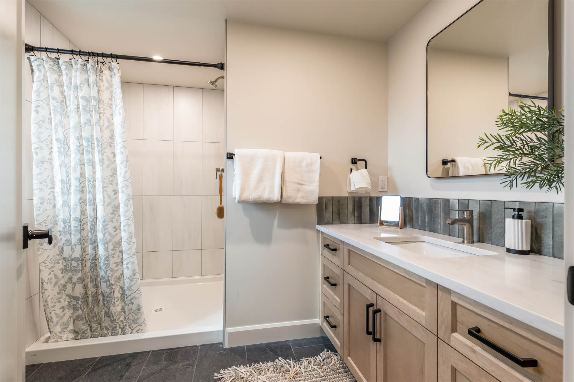 A full bathroom in a tiny home with a large vanity and spacious shower