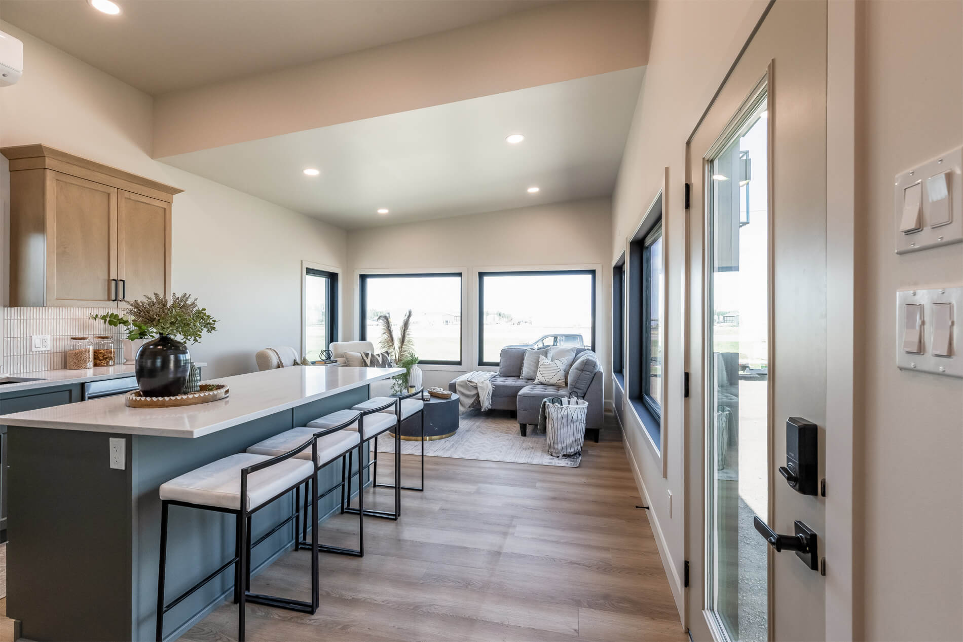 Open concept living area and kitchen with high ceilings in a tiny home