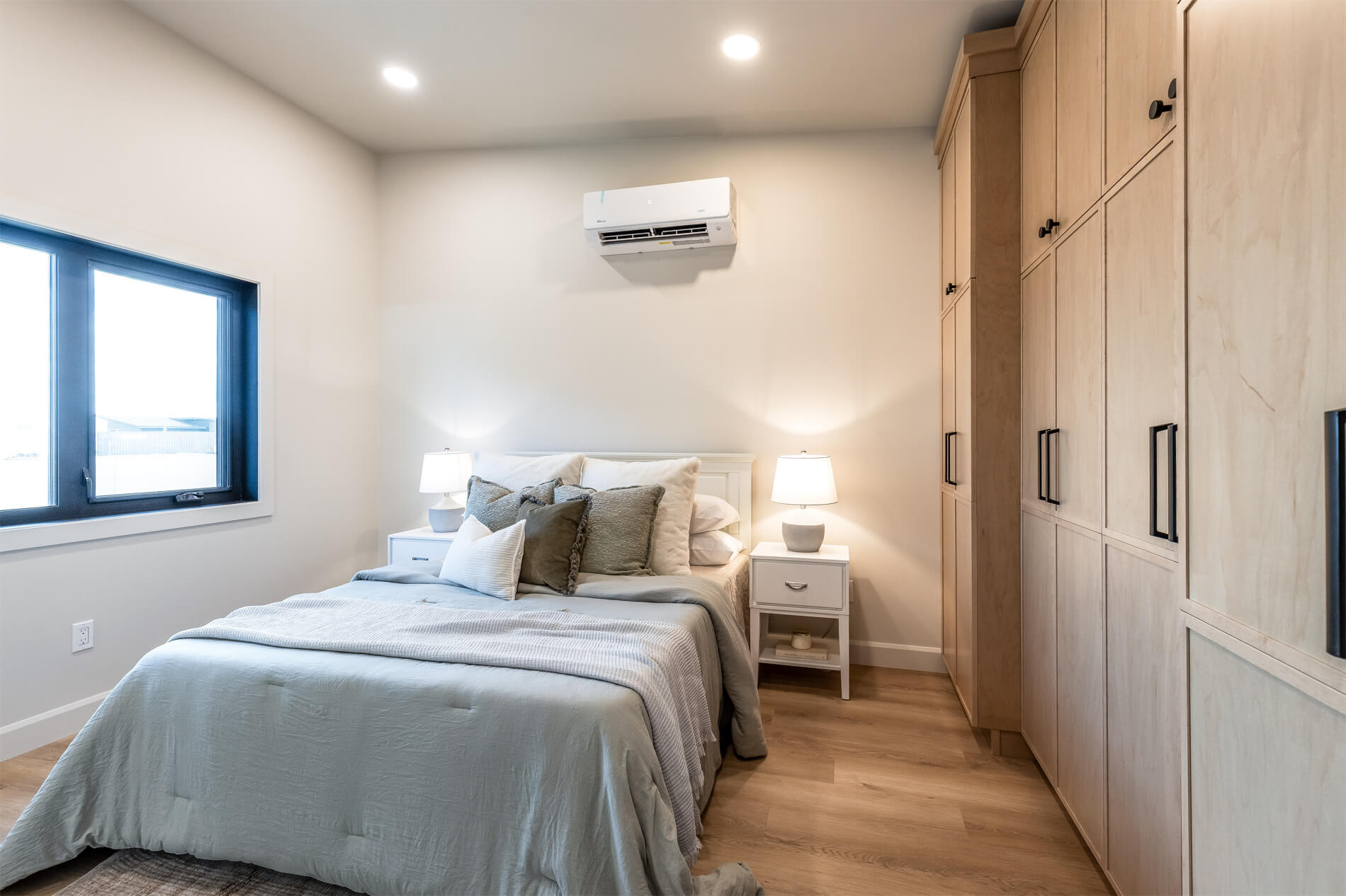 Tiny home master bedroom with ample storage and high celings