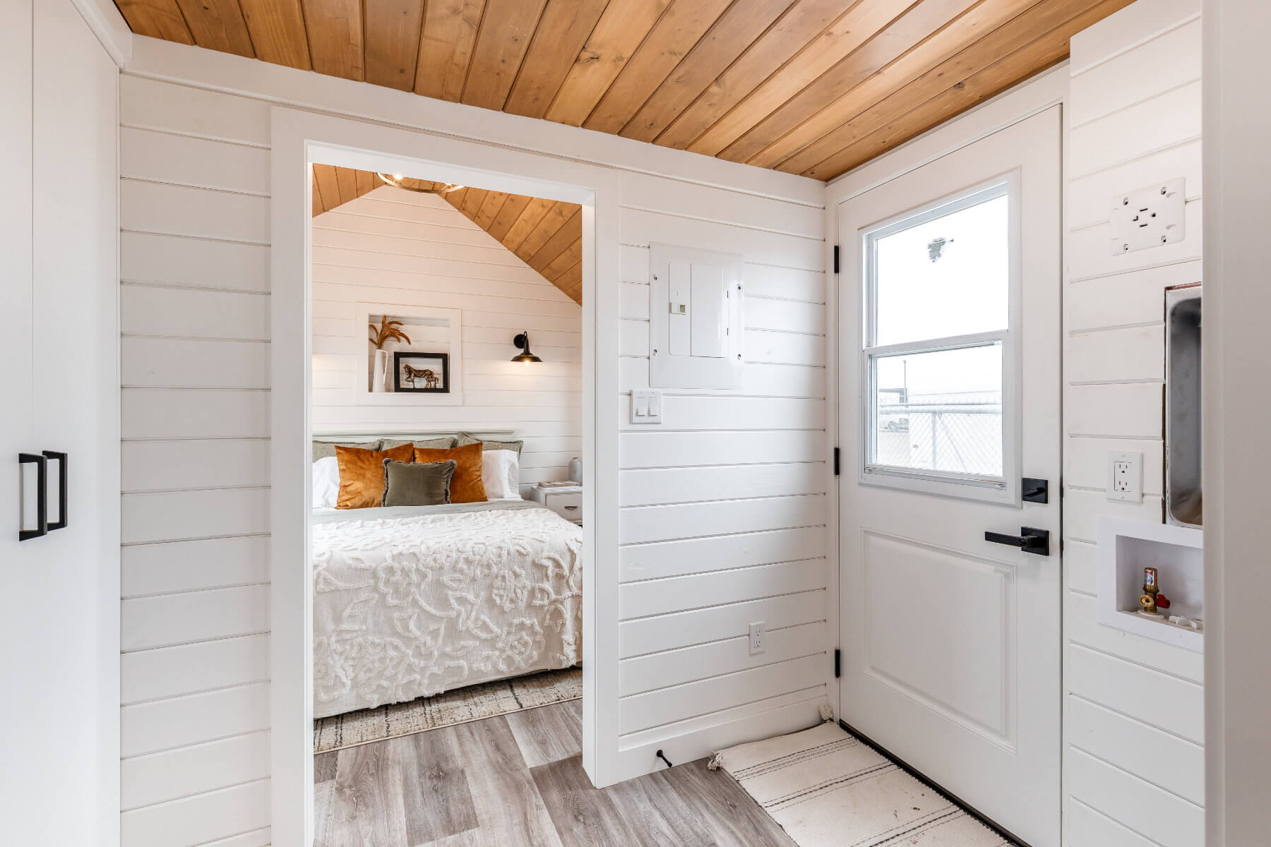 Tiny home entryway with white walls and a white door
