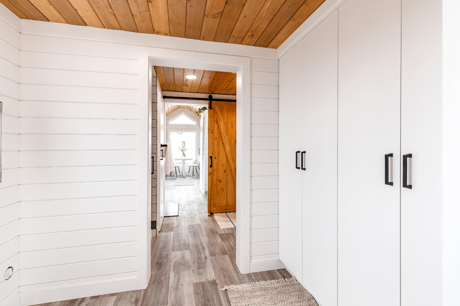 White cabinets providing ample storage in a tiny home