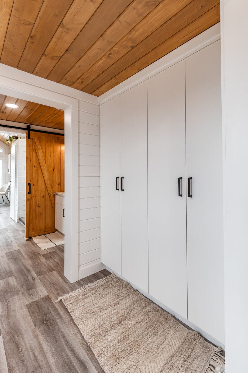 White cabinets providing ample storage in a tiny home