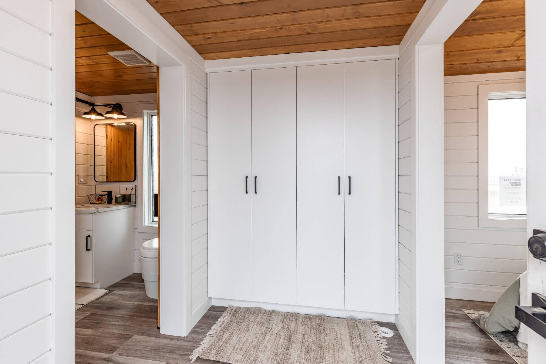 White cabinets providing ample storage in a tiny home