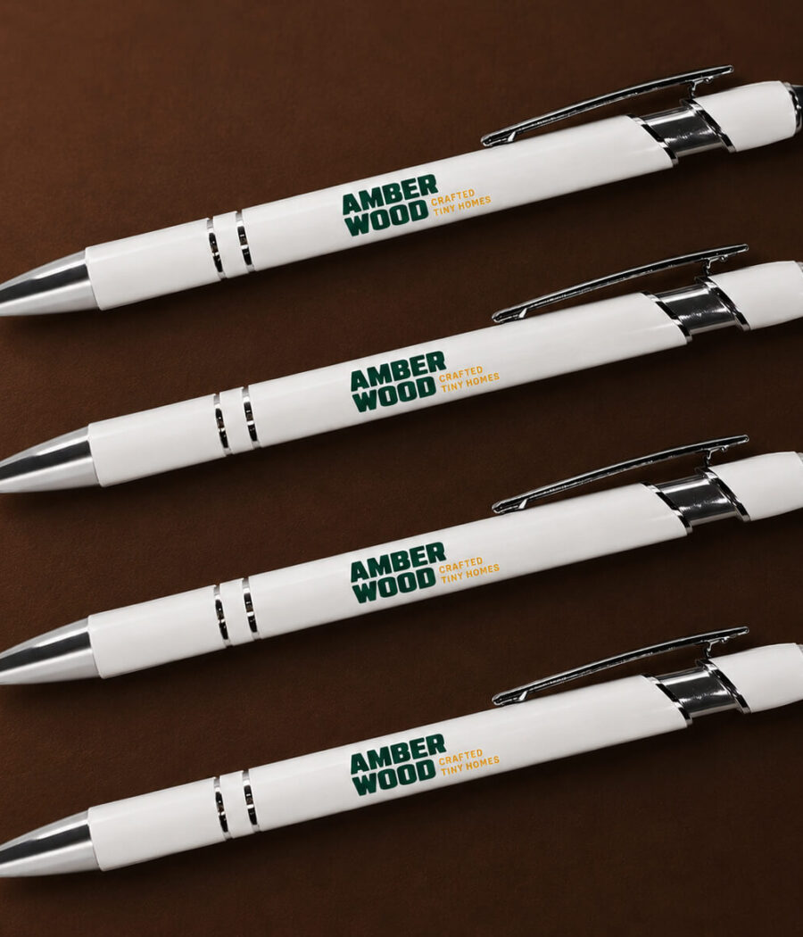 White ballpoint pens with the Amberwood logo on them